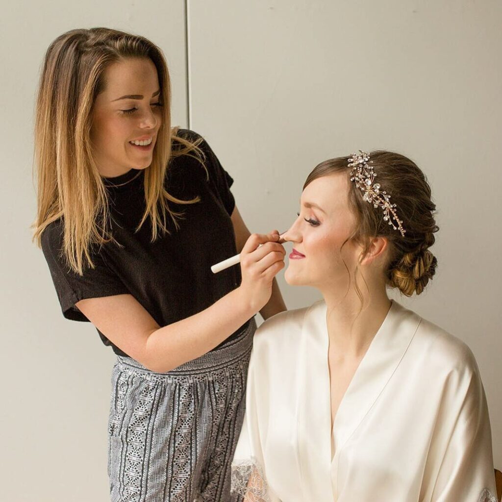 faye appyling makeup on bride